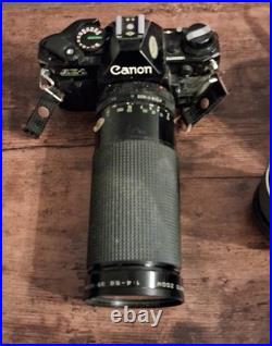 Canon AE-1 Black Vintage SLR Camera with Multiple Lenses and Cases