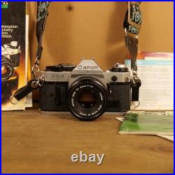 Canon AE-1 Program 35mm SLR Camera w 50mm 1.8 Lens Strap Manuals Vintage Works Canon AE-1 Program 35mm SLR Camera w 50mm 1.8 Lens Strap Manuals Vintage Works