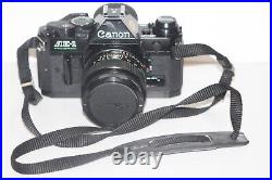 Vintage Black Body Canon AE-1 Program 35mm Film Camera with 50mm 11.4 Lens Tested