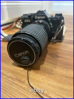 Vintage Canon AE-1 camera with telephoto lens