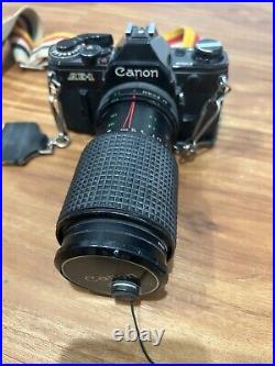 Vintage Canon AE-1 camera with telephoto lens