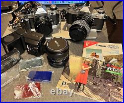Vintage lot of 2 Canon AE-1 cameras (one Program) with lenses, a flash, manuals